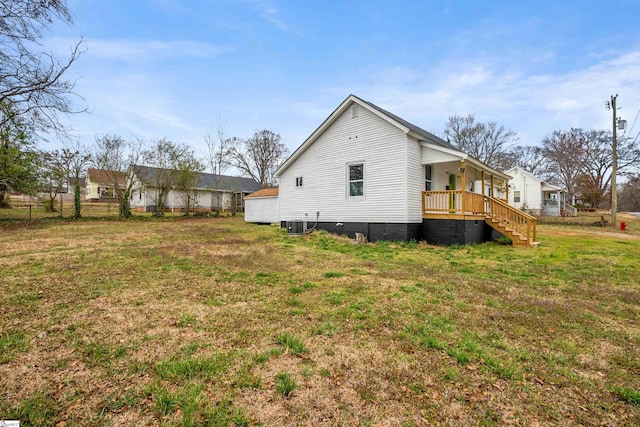 rear view of property with a yard, stairway, fence, and central air condition unit