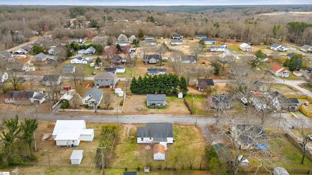 drone / aerial view with a residential view and a wooded view