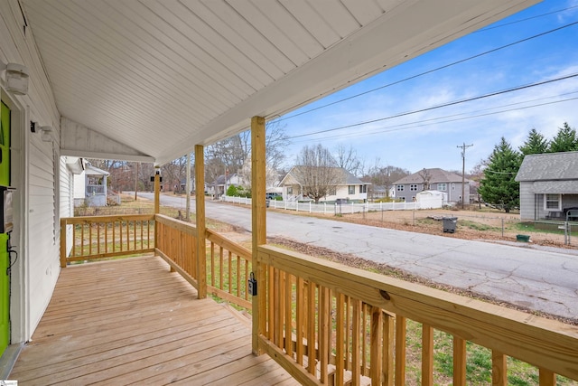 wooden deck with covered porch and a residential view