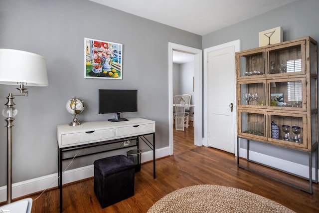 office featuring baseboards and wood finished floors