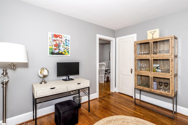 office area featuring baseboards and wood finished floors