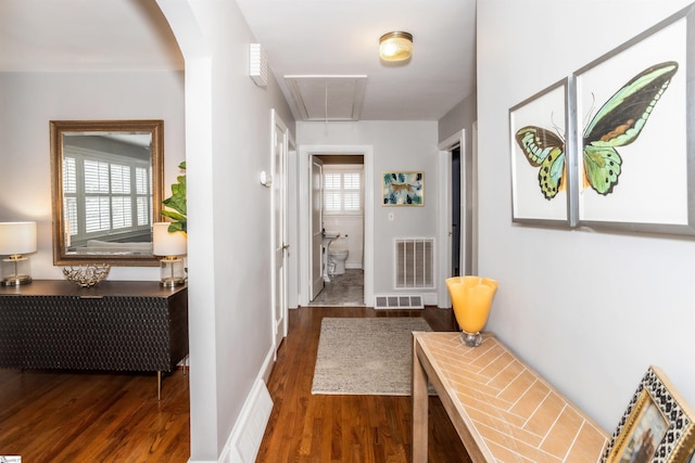 hallway featuring a healthy amount of sunlight, attic access, and visible vents