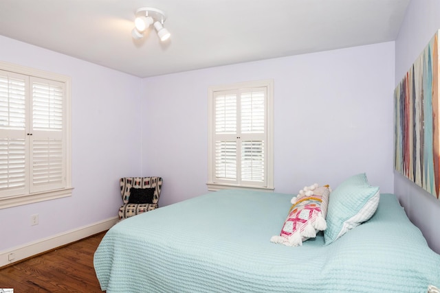 bedroom featuring baseboards and wood finished floors