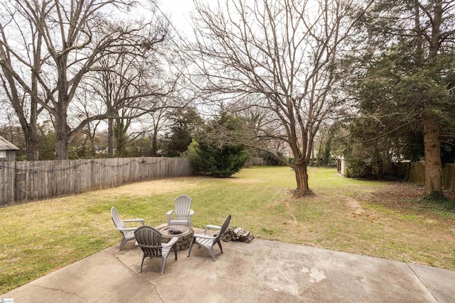 view of yard with an outdoor fire pit, a fenced backyard, and a patio