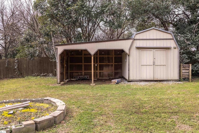 view of pole building with a yard and fence