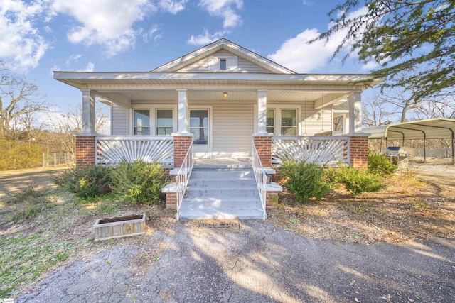 view of front of home with a detached carport and covered porch