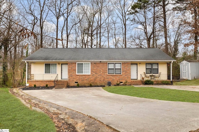 ranch-style home featuring an outbuilding, a porch, a storage shed, brick siding, and crawl space