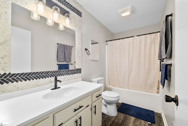 full bathroom with toilet, shower / bath combo with shower curtain, wood finished floors, and vanity