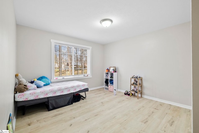 bedroom with wood finished floors and baseboards