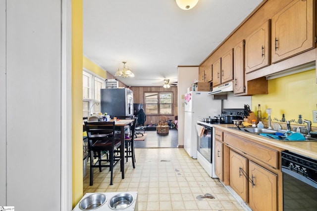 kitchen featuring stainless steel fridge, black dishwasher, electric range, under cabinet range hood, and a sink