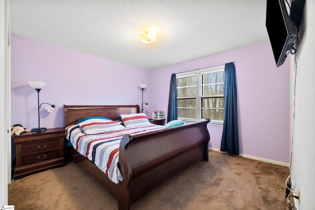 carpeted bedroom with baseboards and a textured ceiling