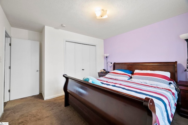 carpeted bedroom with a textured ceiling and a closet