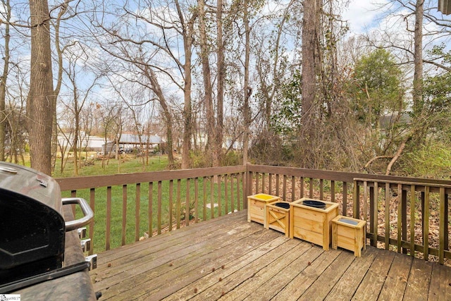 wooden deck with a lawn