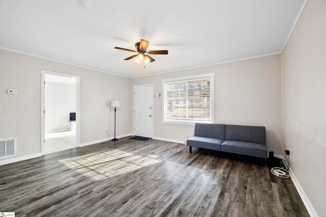 unfurnished room featuring visible vents, baseboards, a ceiling fan, wood finished floors, and crown molding