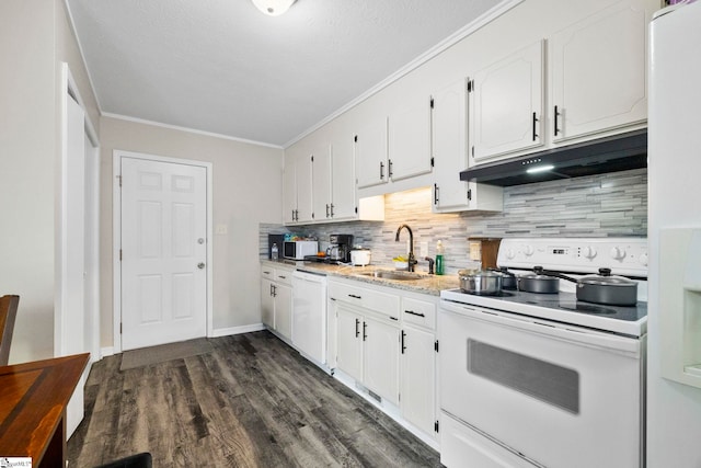 kitchen featuring under cabinet range hood, white appliances, a sink, white cabinets, and crown molding