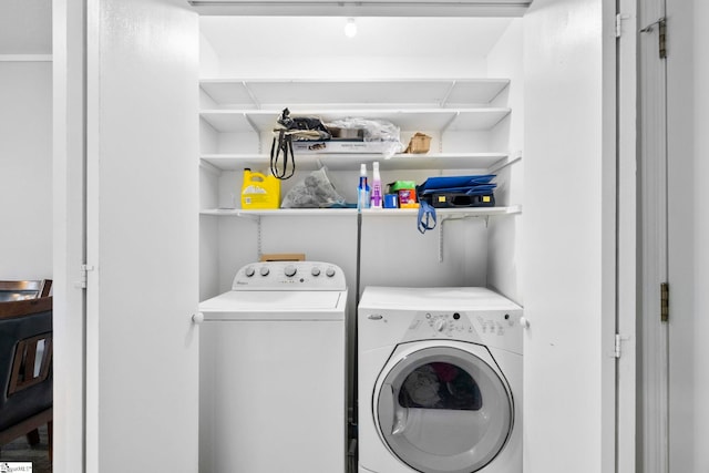 clothes washing area featuring laundry area and separate washer and dryer