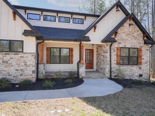 view of front facade with stone siding and board and batten siding