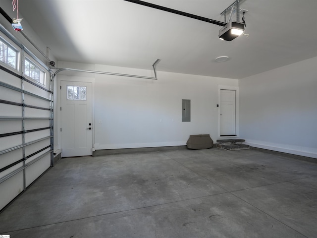 garage featuring electric panel, baseboards, and a garage door opener