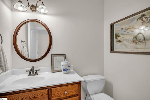 bathroom featuring vanity and toilet