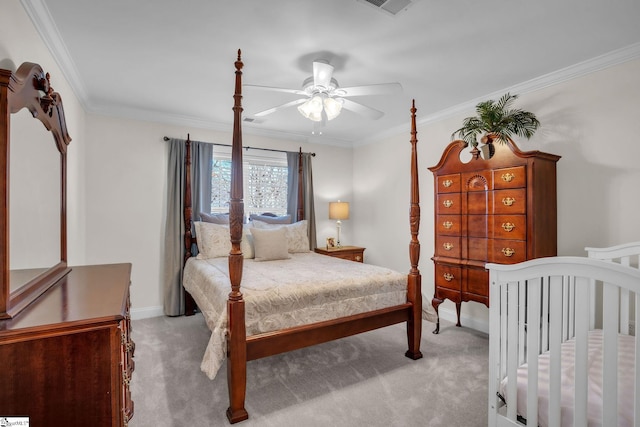 carpeted bedroom featuring ceiling fan, ornamental molding, and baseboards