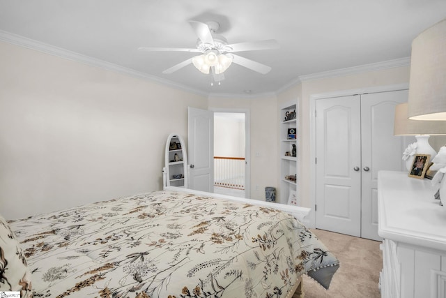 bedroom featuring ornamental molding, a closet, light carpet, and a ceiling fan