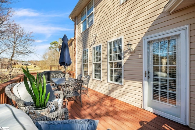 wooden deck featuring outdoor dining area and area for grilling