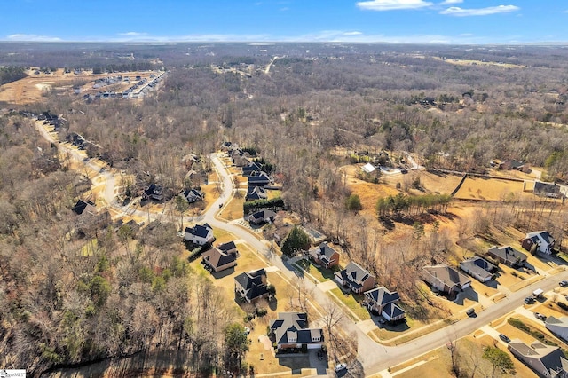 drone / aerial view with a residential view and a forest view