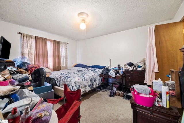 carpeted bedroom featuring a textured ceiling