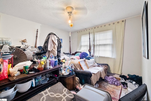 bedroom with ceiling fan and a textured ceiling