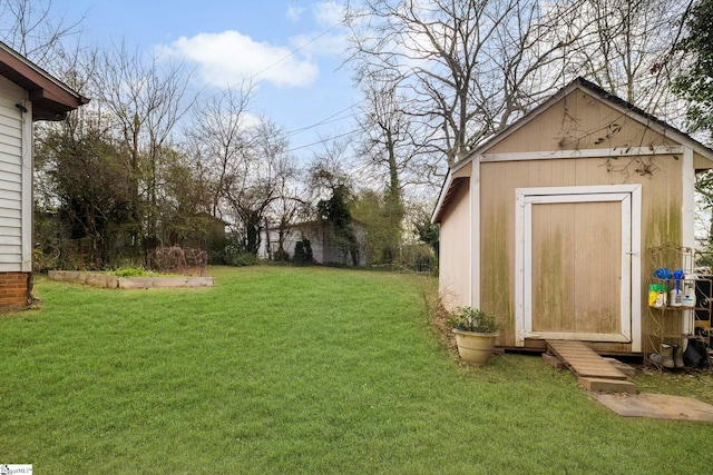 view of yard featuring a storage shed and an outbuilding