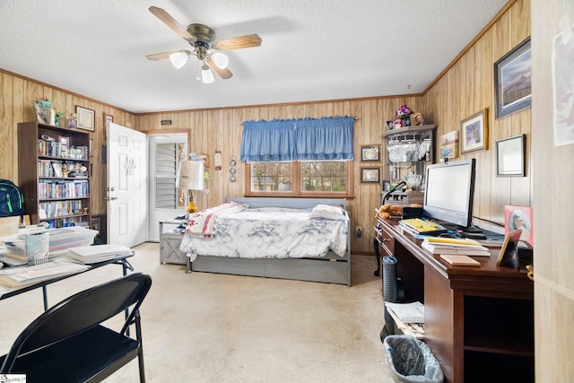 bedroom featuring light carpet, wood walls, crown molding, and a textured ceiling