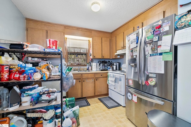 kitchen with white range with electric stovetop, stainless steel fridge with ice dispenser, a textured ceiling, under cabinet range hood, and a sink