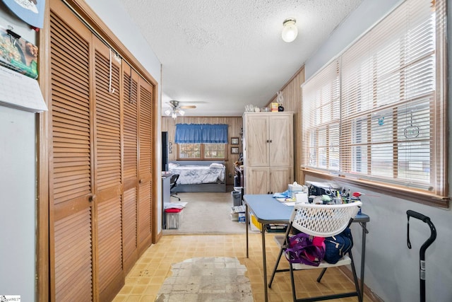 dining space with ceiling fan and a textured ceiling