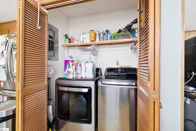 laundry room featuring laundry area, separate washer and dryer, and electric panel