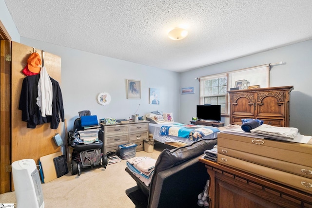 bedroom featuring a textured ceiling and carpet flooring