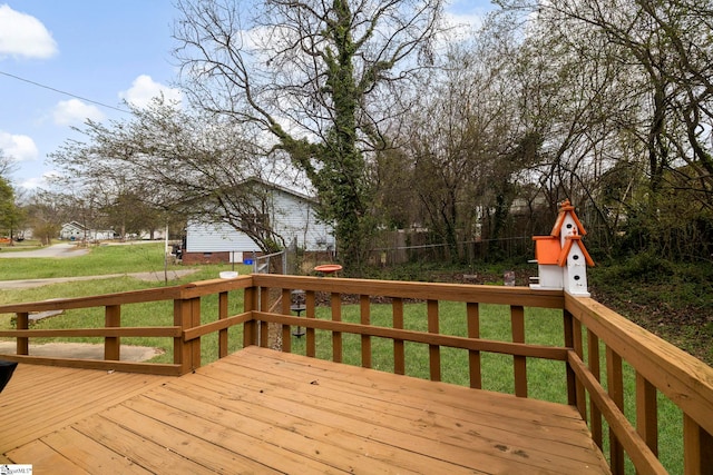 wooden terrace featuring a lawn