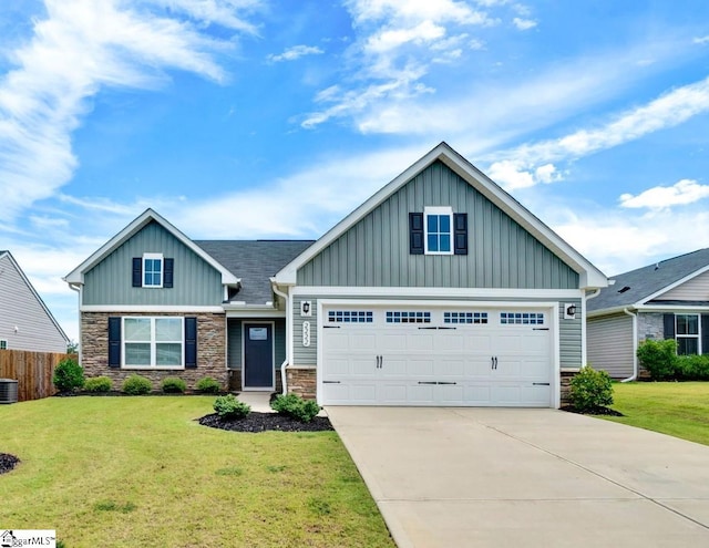 craftsman inspired home featuring board and batten siding, a front yard, concrete driveway, and stone siding