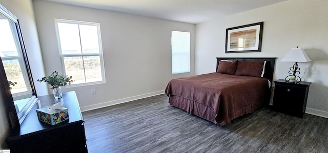 bedroom featuring dark wood-style floors and baseboards