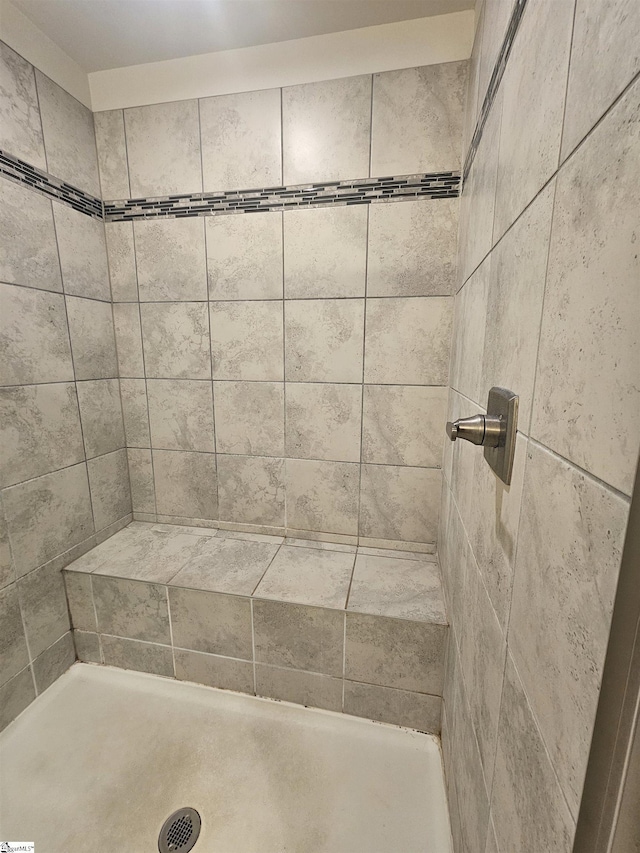 full bathroom with a tile shower