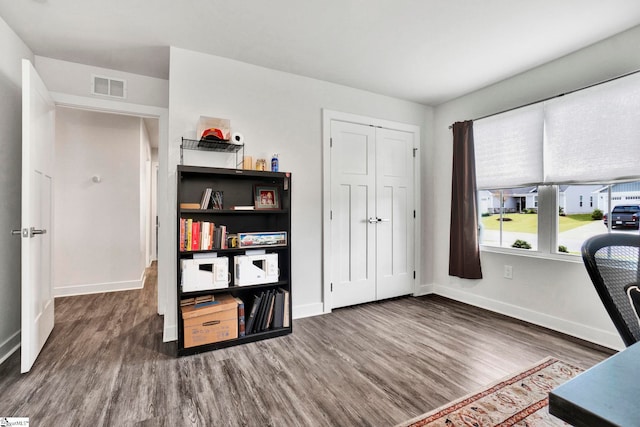 office with wood finished floors, visible vents, and baseboards