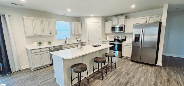 kitchen with light wood finished floors, visible vents, appliances with stainless steel finishes, and a sink