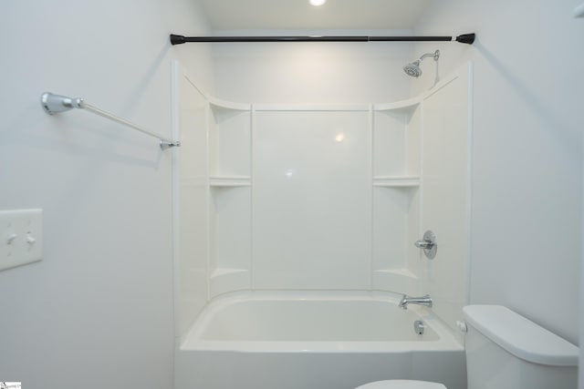 bathroom featuring tub / shower combination and toilet