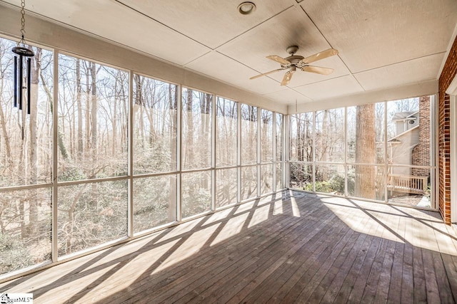 unfurnished sunroom with a ceiling fan