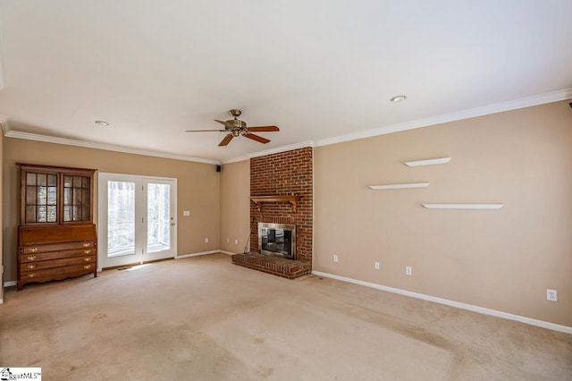 unfurnished living room with a brick fireplace, light carpet, crown molding, and baseboards