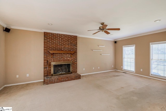 unfurnished living room with carpet, a brick fireplace, baseboards, and crown molding