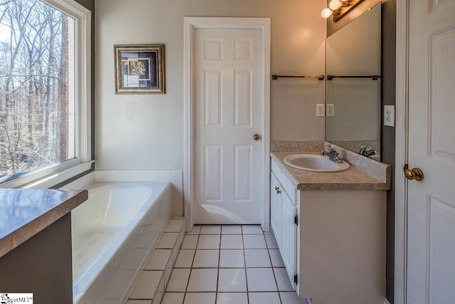 bathroom featuring a garden tub, plenty of natural light, vanity, and tile patterned floors