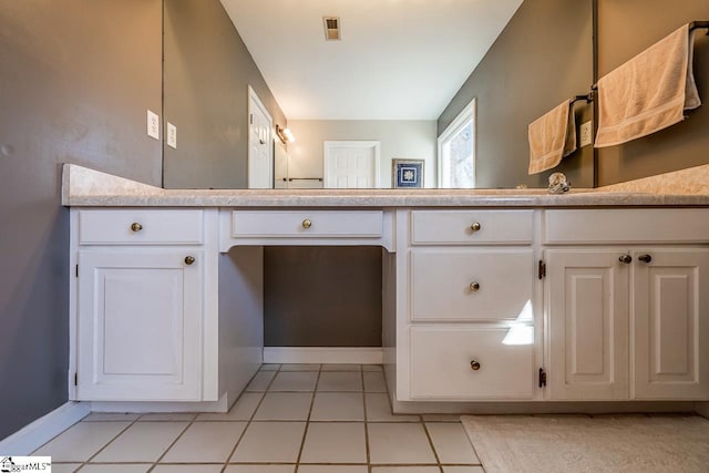 bathroom with tile patterned flooring, visible vents, and baseboards