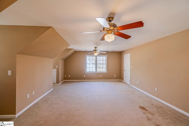 additional living space with light carpet, baseboards, and a ceiling fan