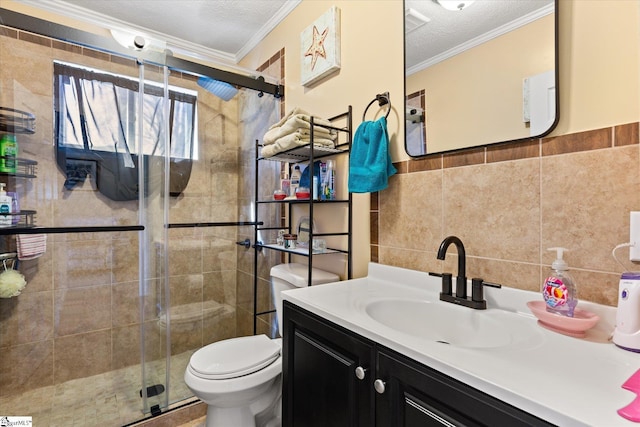 bathroom with a textured ceiling, toilet, tile walls, a stall shower, and crown molding