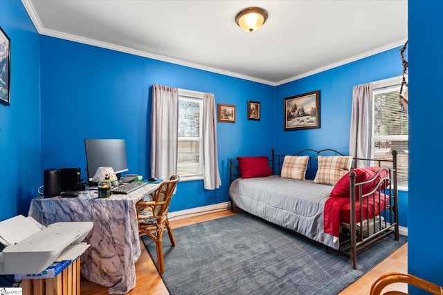 bedroom featuring multiple windows, wood finished floors, and crown molding